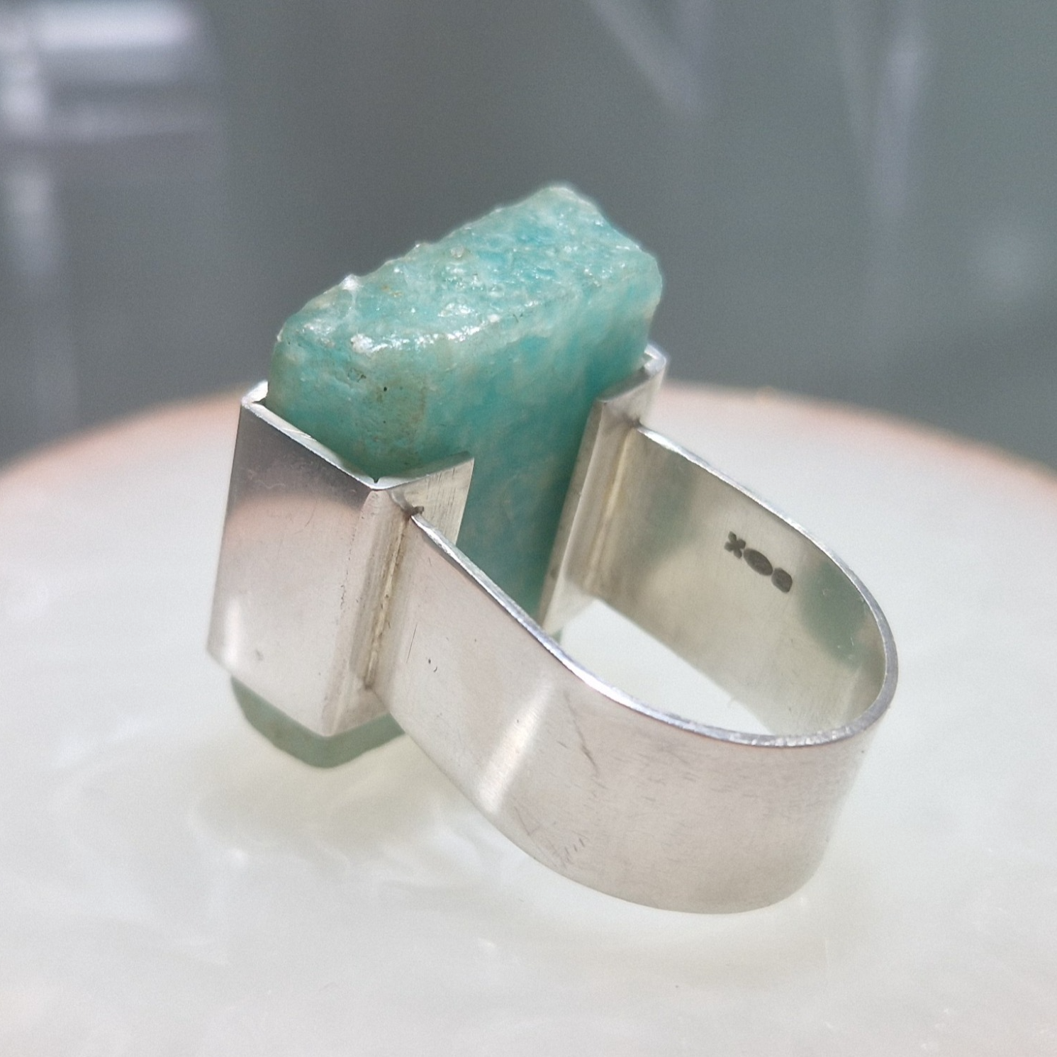 A silver bracket set ring with a slab of raw amazonite - Julia Mathias Jewellery