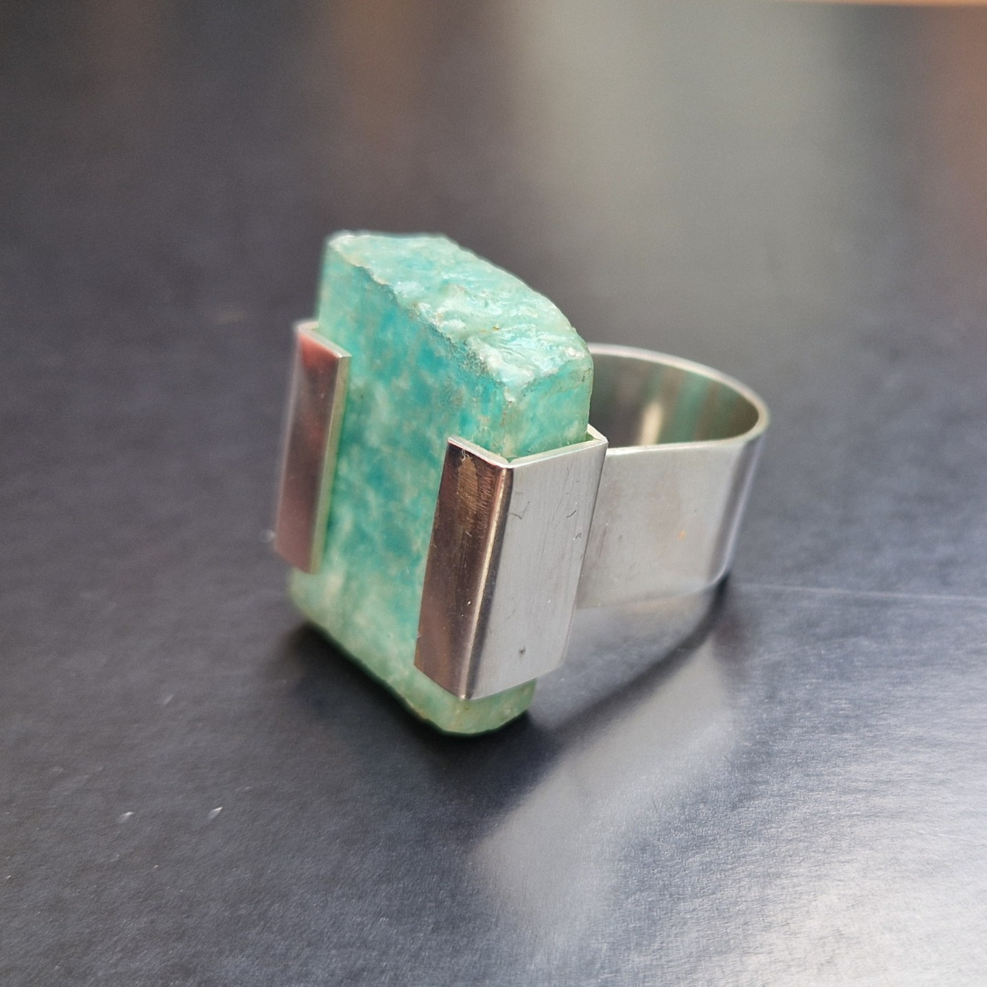 A silver bracket set ring with a slab of raw amazonite - Julia Mathias Jewellery