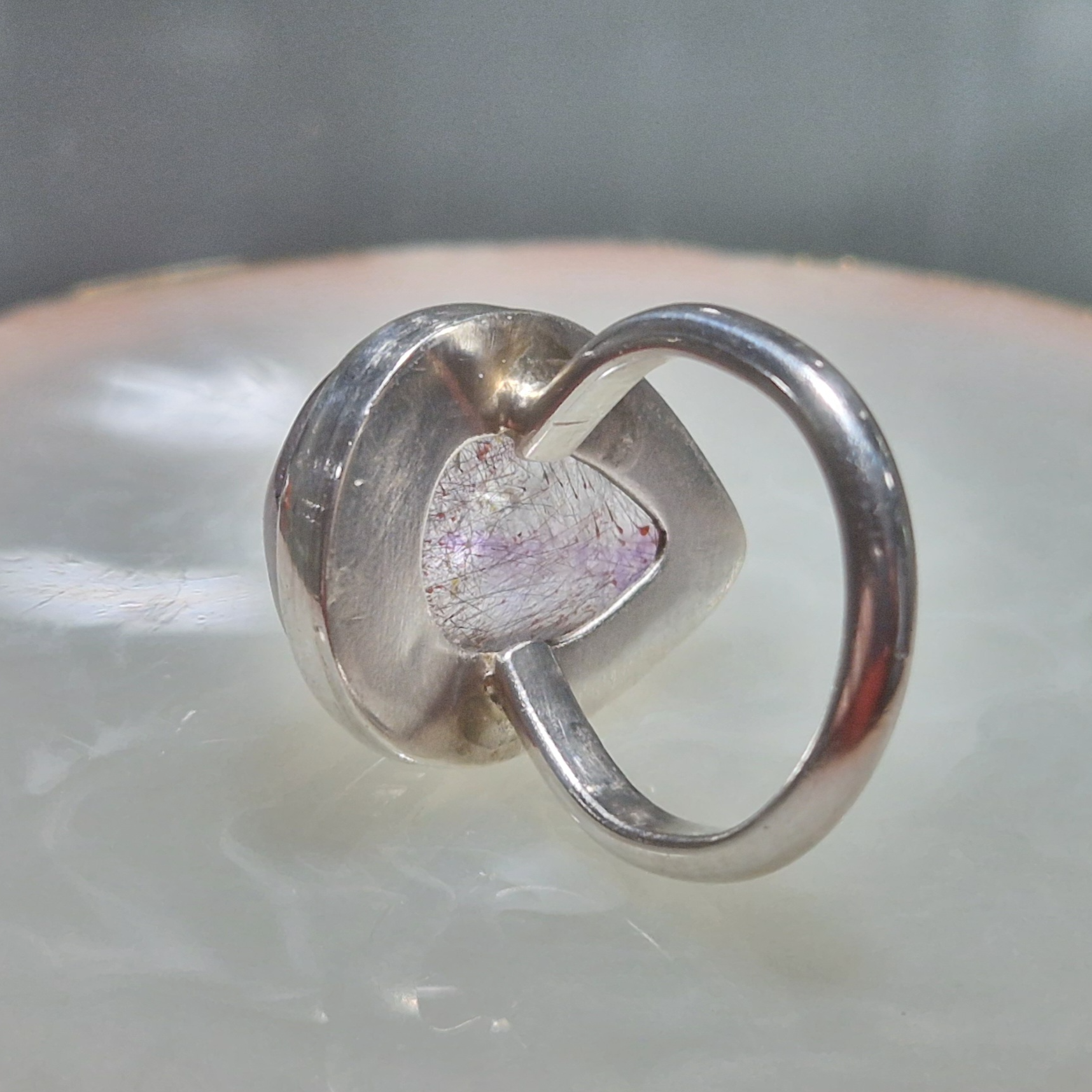 A silver ring set with an amethyst rutile quartz - Julia Mathias Jewellery
