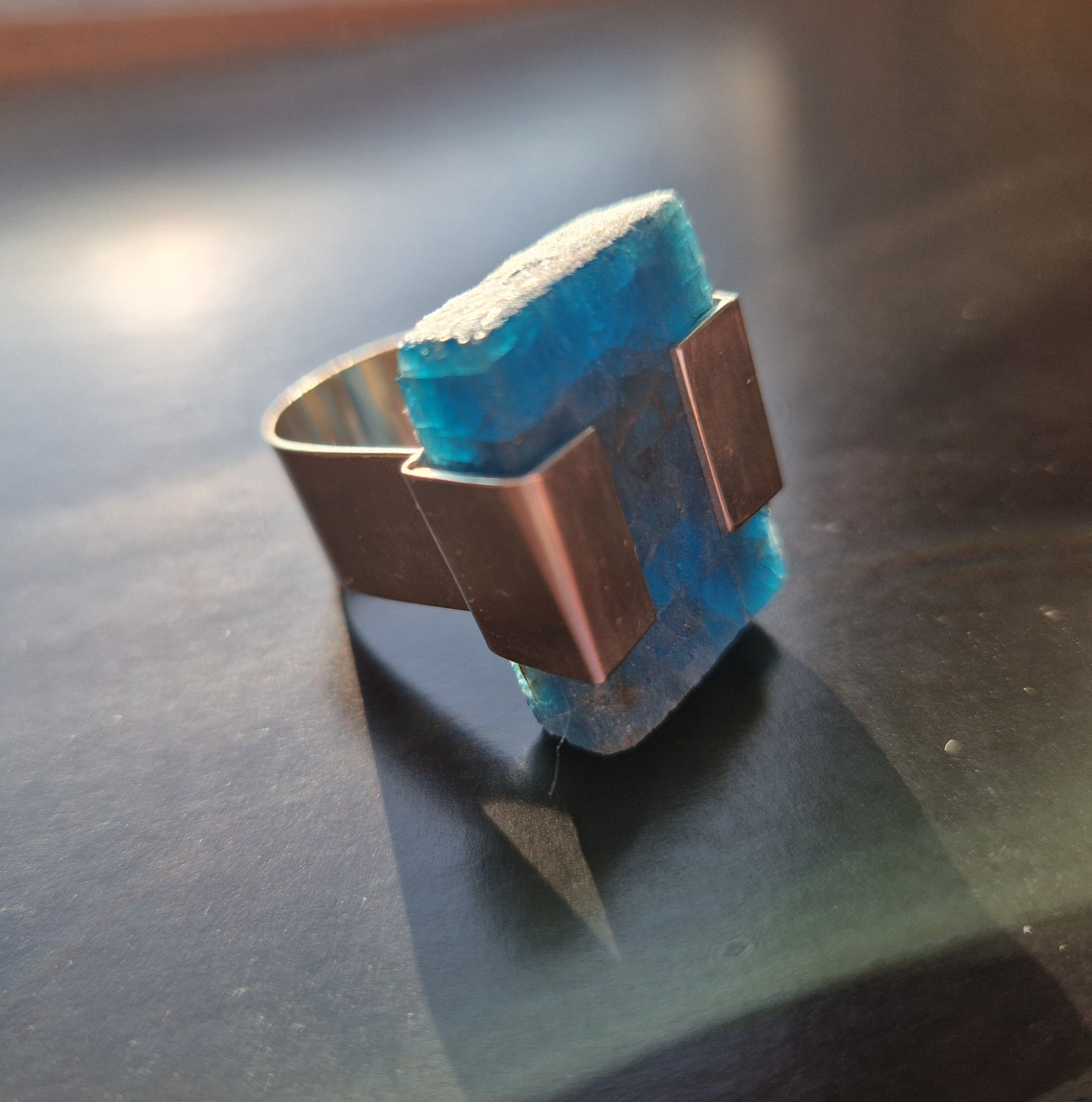 Silver ring set with a natural blue apatite