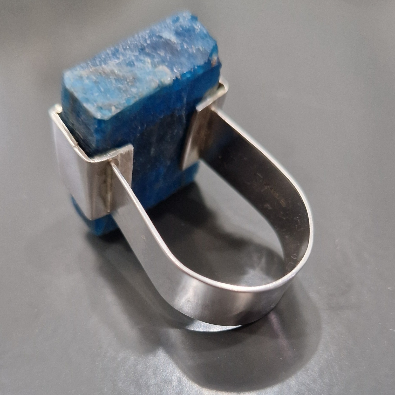 Silver ring set with a natural blue apatite