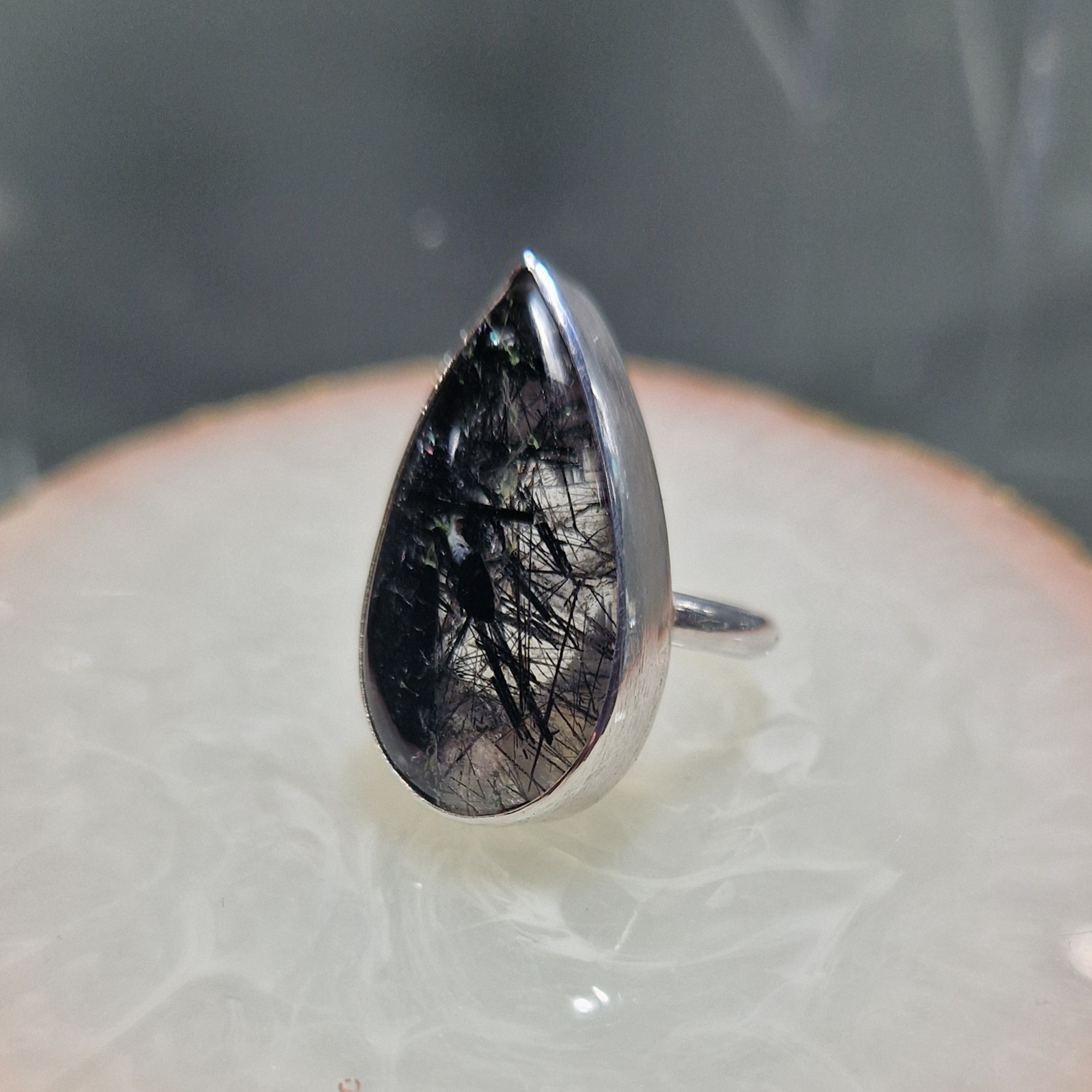 Silver ring set with a pear shaped black rutile quartz