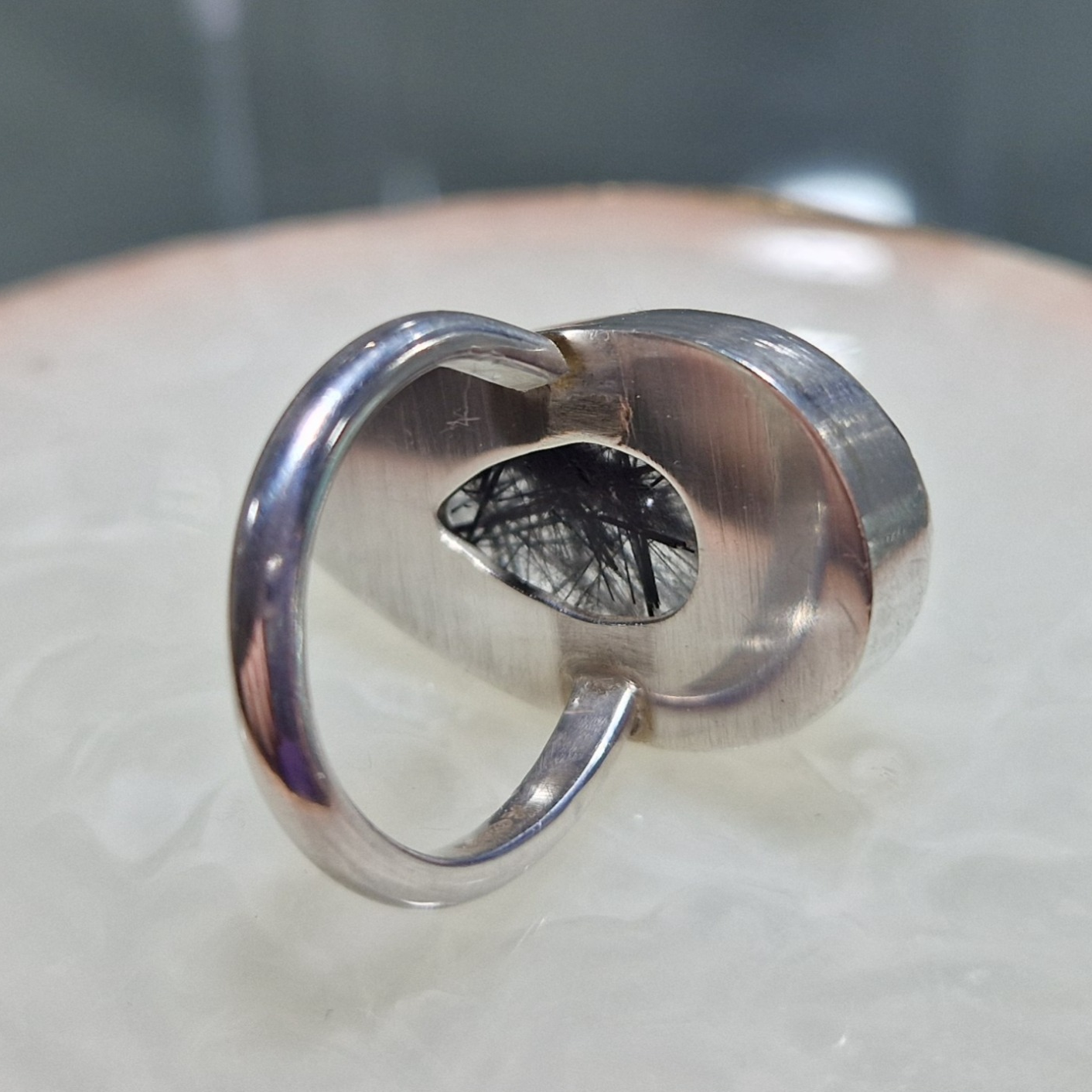 Silver ring set with a pear shaped black rutile quartz