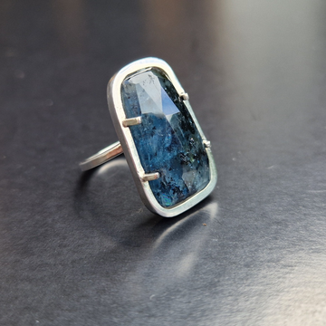 A silver ring set with a facetted Kyanite stone